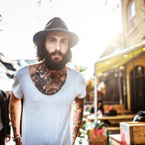 Hipster portrait with body full of tattoo